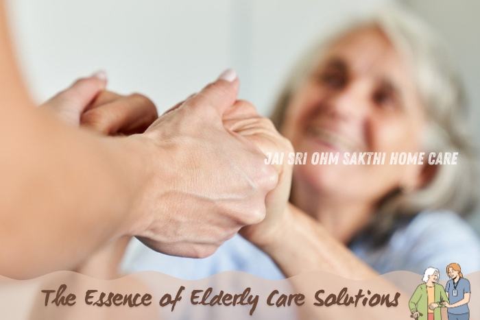 Smiling elderly woman holding hands with a caregiver, illustrating the compassionate elderly care solutions provided by Jai Sri Ohm Sakthi Home Care in Coimbatore, emphasizing dignity and personalized support.