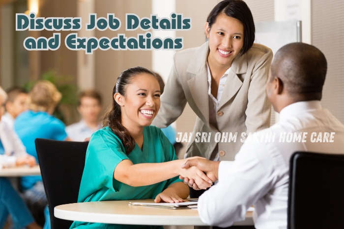 Smiling woman in a green uniform shaking hands with a man while another woman looks on, discussing job details and expectations, showcasing the professional and thorough hiring process at Jai Sri Ohm Sakthi Home Care in Coimbatore