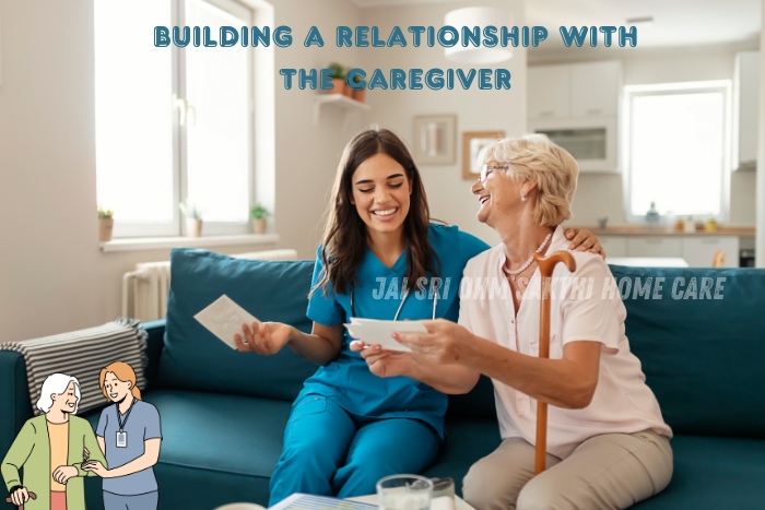 A caregiver and an elderly woman happily interacting at home, representing the warm and supportive services offered by Jai Sri Ohm Sakthi Home Care in Coimbatore. The caregiver, dressed in a blue uniform, is assisting the woman with documents, showing the importance of building a relationship with caregivers for better home nursing and care services