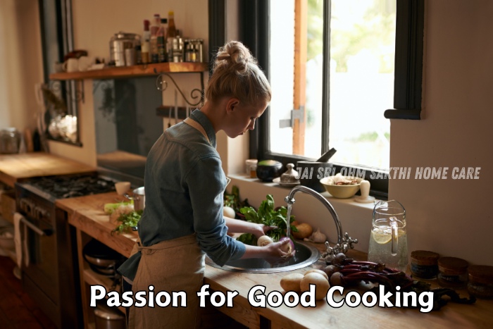 A woman with blonde hair, wearing a denim shirt, washing vegetables in a cozy kitchen filled with fresh ingredients. This image reflects the passion for good cooking, showcasing the home cooking services provided by Jai Sri Ohm Sakthi Home Care in Coimbatore